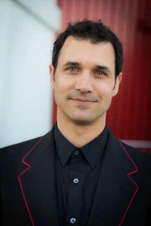 A portrait of Ramin Djawadi smiling at camera