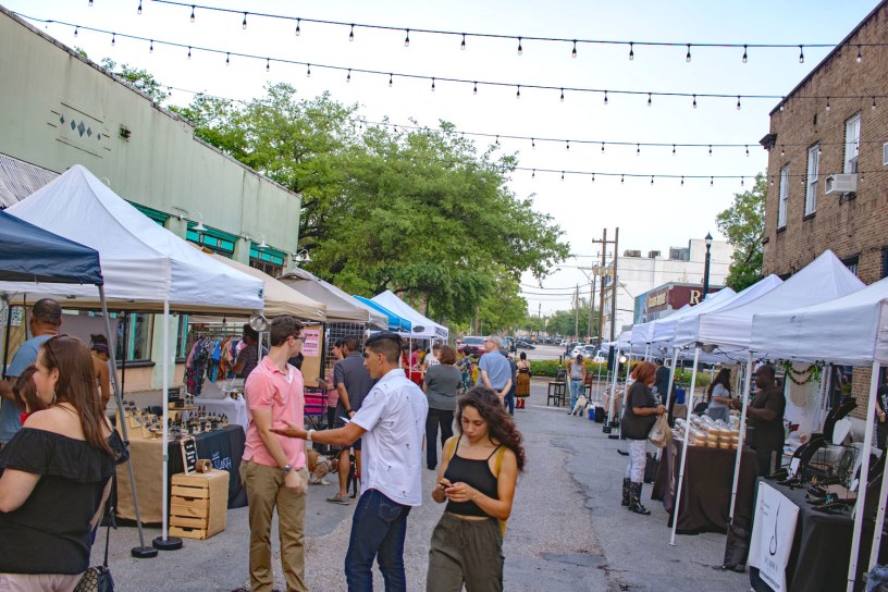A wide shot of a street with rows of vendor tables on either side