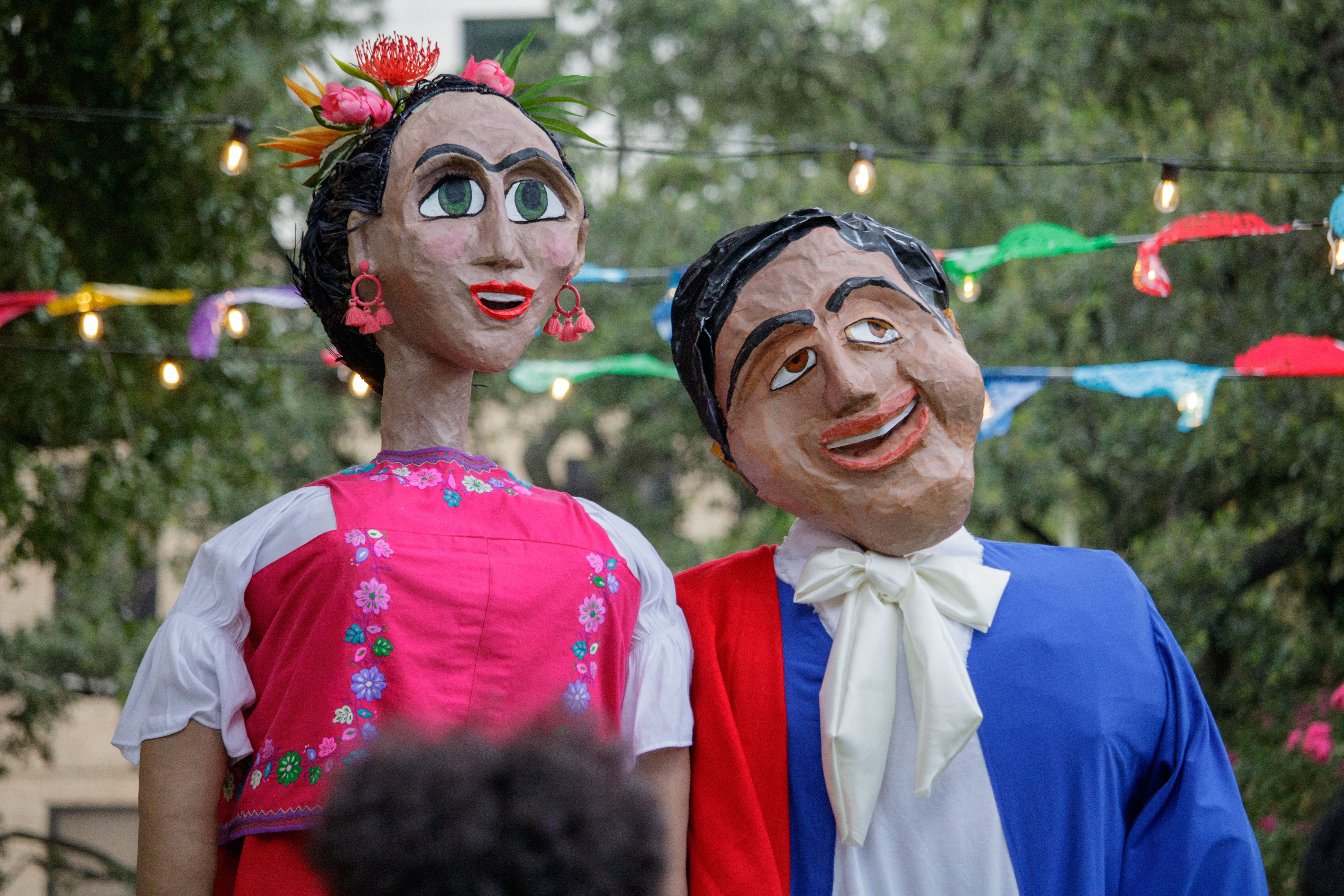 A picture of two giant paper mache puppets